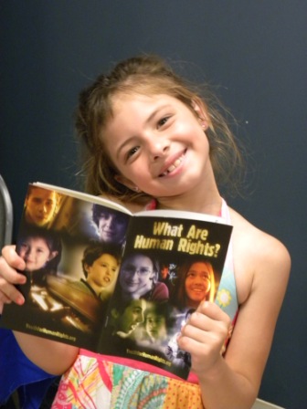 Kid with What are Human Rights booklet.JPG